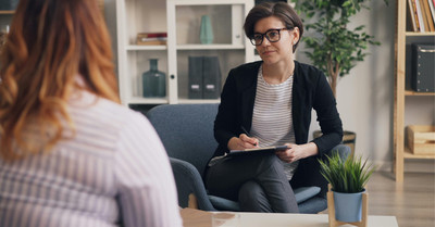 Client engaging in a compassionate, solution-focused therapy session aimed at personal growth and emotional healing.