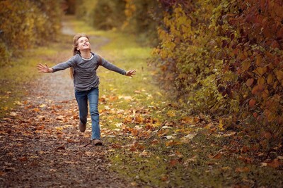 Child walking along a peaceful nature path symbolizing emotional growth and well-being